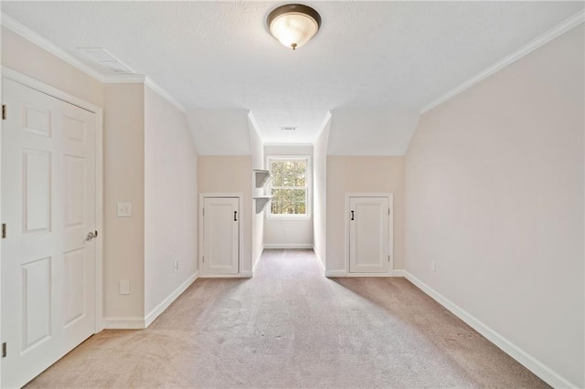 bonus room with light colored carpet, a textured ceiling, and baseboards