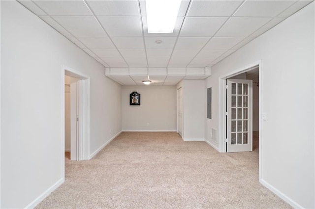 interior space with a paneled ceiling, visible vents, carpet floors, and baseboards