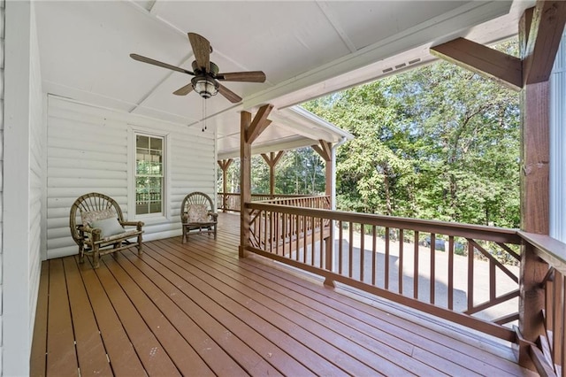 wooden terrace featuring a ceiling fan