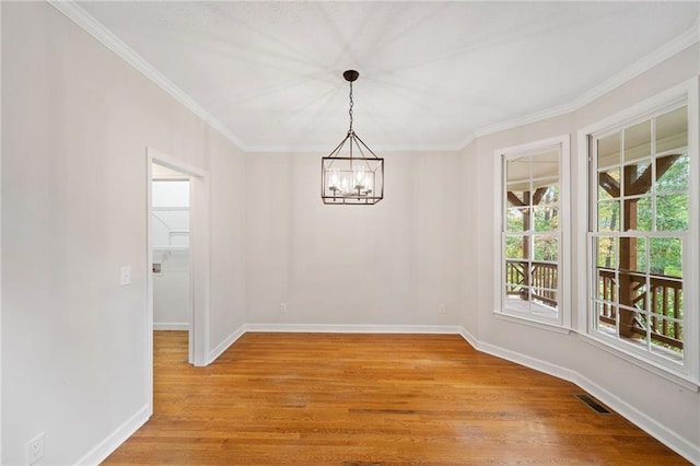 unfurnished dining area featuring crown molding, baseboards, visible vents, and light wood-type flooring