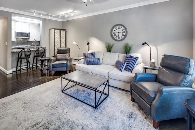 living room with rail lighting, ornamental molding, and dark hardwood / wood-style flooring