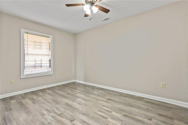 empty room with ceiling fan and light wood-type flooring