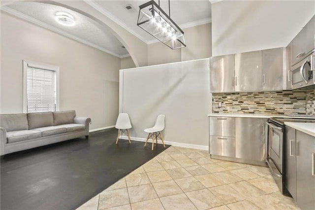 kitchen featuring pendant lighting, light tile patterned floors, appliances with stainless steel finishes, tasteful backsplash, and ornamental molding