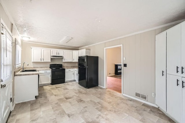 kitchen with sink, crown molding, black appliances, and white cabinets