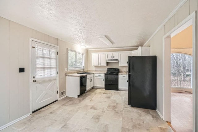 kitchen featuring sink, white cabinets, ornamental molding, black appliances, and a textured ceiling