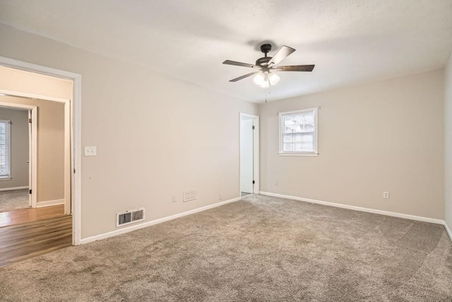 carpeted empty room with ceiling fan