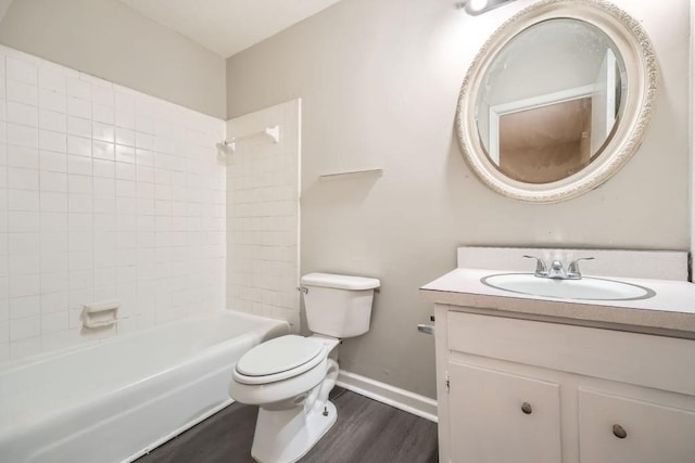 full bathroom with vanity, tiled shower / bath, wood-type flooring, and toilet