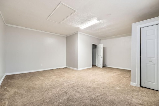 carpeted empty room featuring crown molding