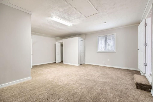 interior space with light carpet, crown molding, and a textured ceiling