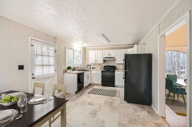 kitchen with white cabinetry, sink, black appliances, crown molding, and a textured ceiling