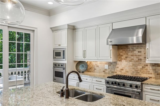 3113 Lenox Rd NE Unit 6, Atlanta, GA 30324 - kitchen featuring a sink, appliances with stainless steel finishes, wall chimney range hood, light stone countertops, and backsplash