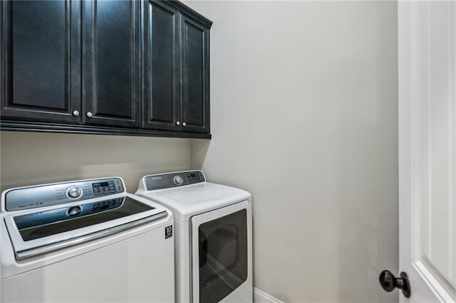 3113 Lenox Rd NE Unit 6, Atlanta, GA 30324 - laundry room featuring washing machine and clothes dryer, cabinet space, and baseboards