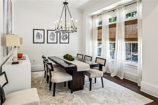 3113 Lenox Rd NE Unit 6, Atlanta, GA 30324 - dining space with baseboards, wood finished floors, a chandelier, and crown molding