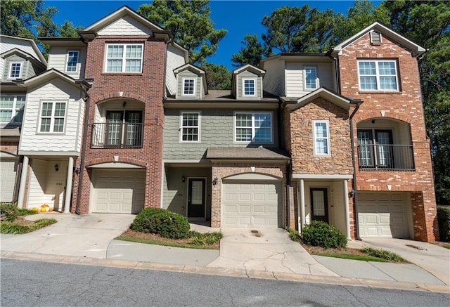 view of property with a balcony and a garage