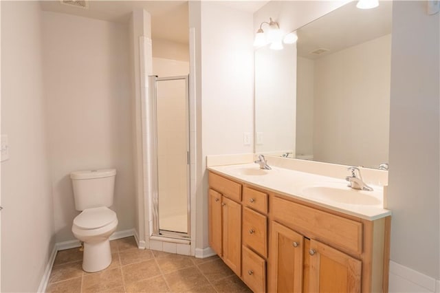 bathroom featuring a shower with door, tile patterned floors, vanity, and toilet