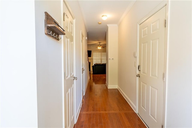 corridor featuring ornamental molding and hardwood / wood-style flooring