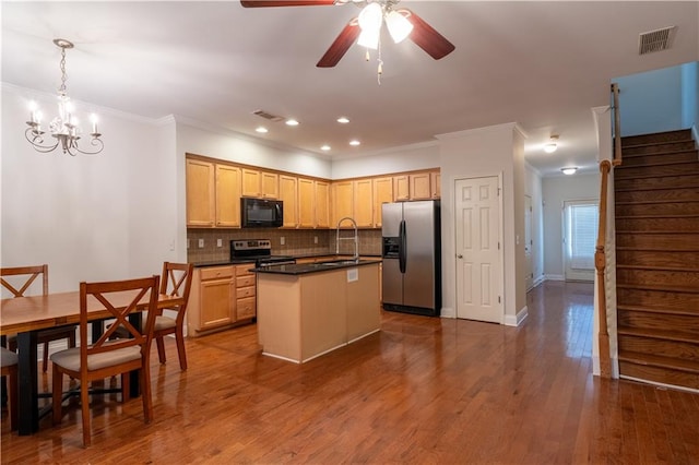 kitchen with a kitchen island with sink, light brown cabinetry, dark hardwood / wood-style flooring, sink, and appliances with stainless steel finishes