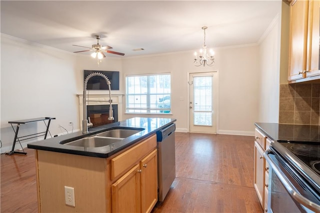 kitchen with ornamental molding, wood-type flooring, a center island with sink, backsplash, and stainless steel appliances