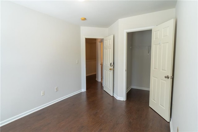 unfurnished bedroom with a closet and dark hardwood / wood-style floors