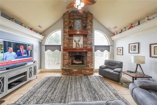 living room featuring a fireplace, plenty of natural light, light tile patterned flooring, and high vaulted ceiling