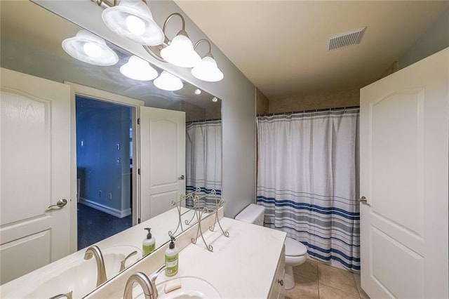 bathroom featuring toilet, vanity, tile patterned flooring, and curtained shower