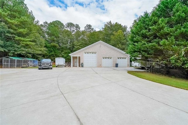 view of side of home featuring an outbuilding and a garage