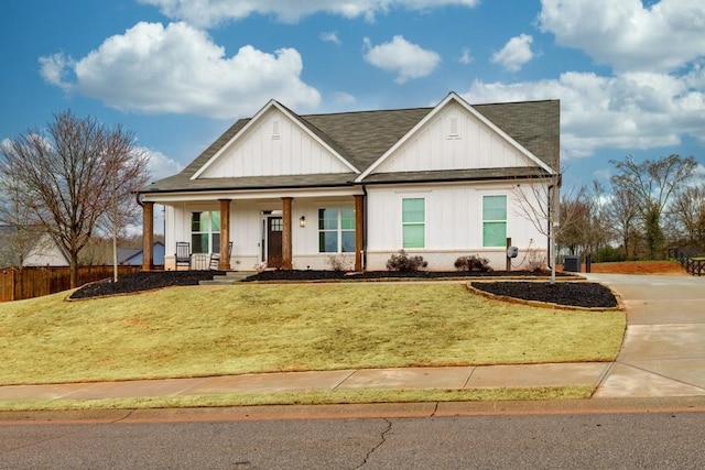 view of front of home with a porch and a front yard