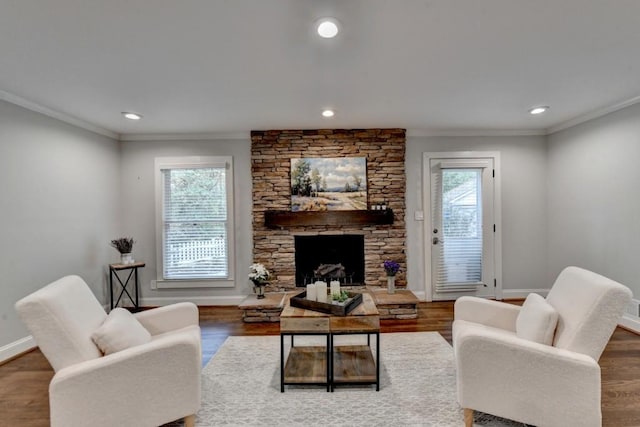 living room with a healthy amount of sunlight, baseboards, ornamental molding, and wood finished floors