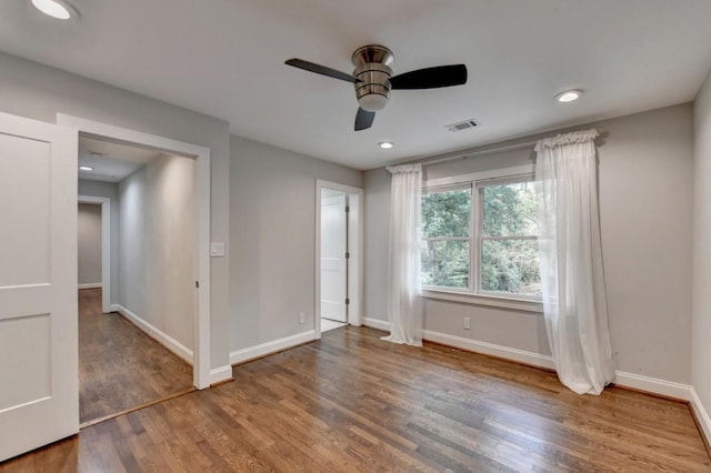 unfurnished bedroom with recessed lighting, wood finished floors, visible vents, and baseboards