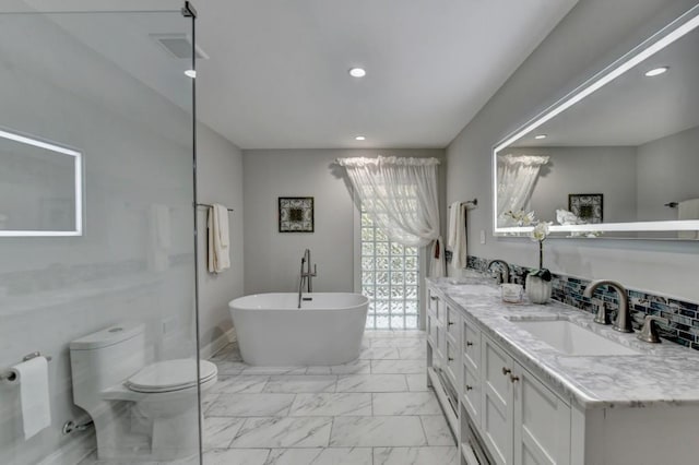 bathroom featuring a sink, visible vents, a freestanding bath, and marble finish floor