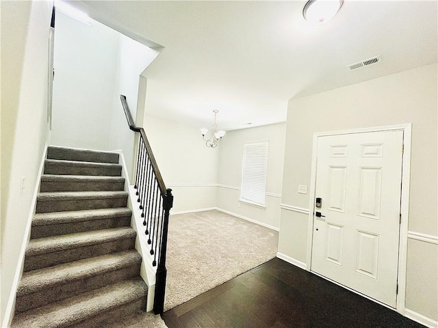 4417 Belcamp Rd, Fairburn, GA 30213 - entrance foyer with dark wood-style flooring, a chandelier, and stairs