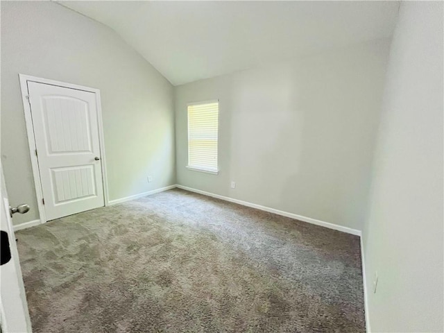 4417 Belcamp Rd, Fairburn, GA 30213 - carpeted empty room featuring vaulted ceiling and baseboards