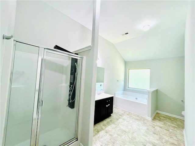 4417 Belcamp Rd, Fairburn, GA 30213 - full bath featuring vanity, vaulted ceiling, a stall shower, and a bath