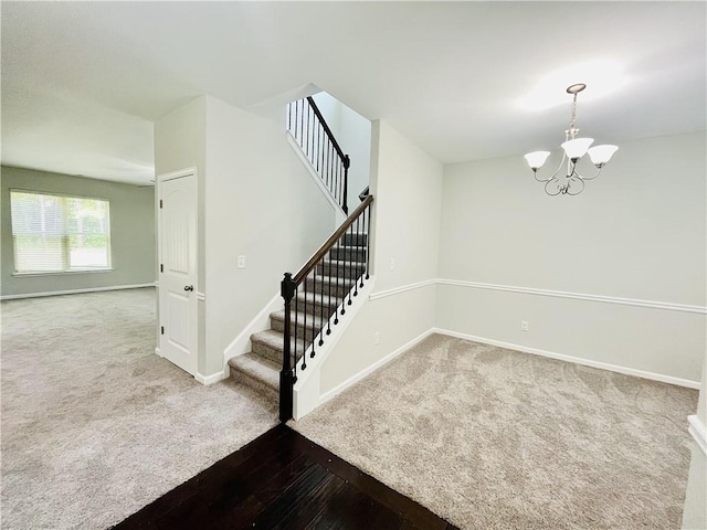 4417 Belcamp Rd, Fairburn, GA 30213 - staircase featuring a chandelier, carpet, and wood-type flooring