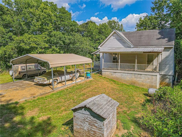 exterior space featuring covered porch, a carport, and a yard