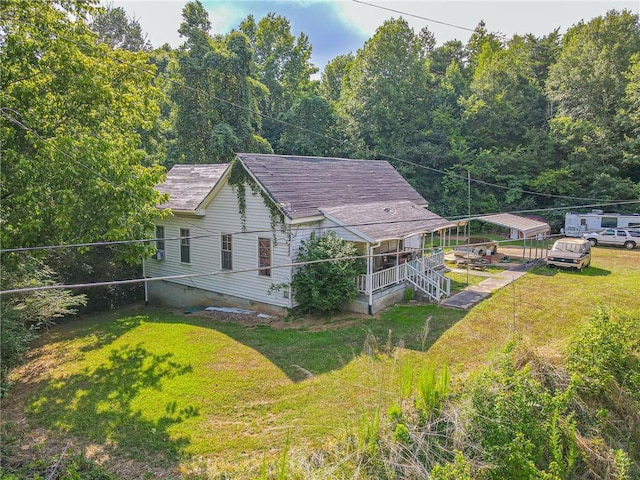 view of side of property with a yard and a deck