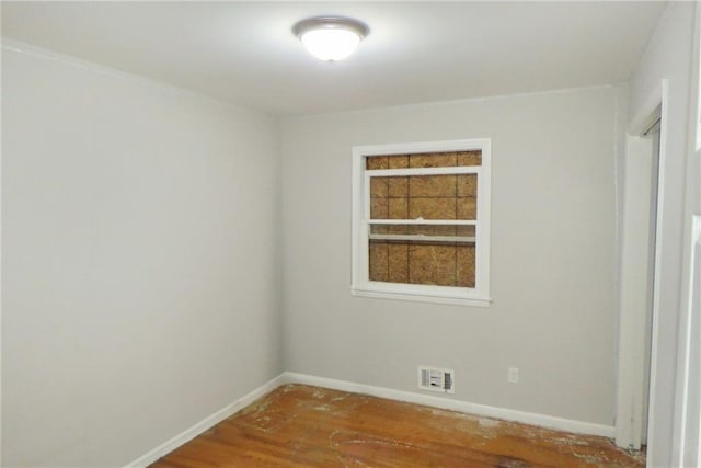 empty room with hardwood / wood-style flooring