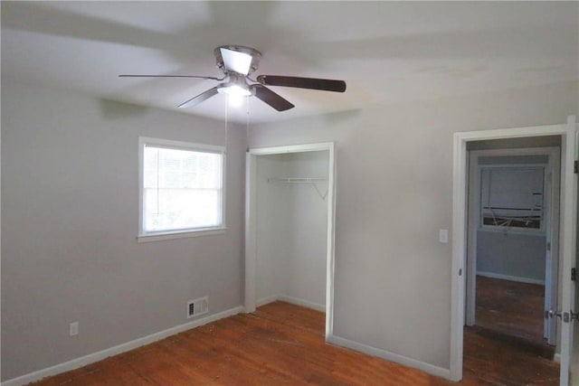 unfurnished bedroom featuring ceiling fan, a closet, and dark hardwood / wood-style floors