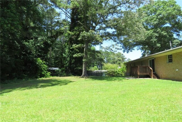 view of yard featuring a wooden deck