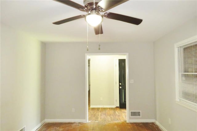 empty room with ceiling fan and light hardwood / wood-style flooring