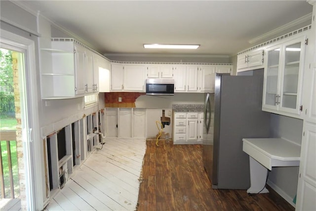 kitchen with stainless steel appliances, ornamental molding, dark hardwood / wood-style flooring, and white cabinetry