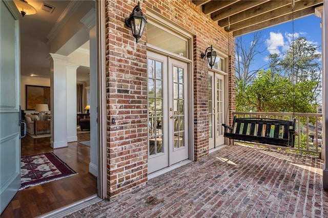 wooden terrace with visible vents and french doors