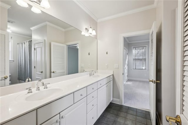 bathroom featuring a sink, ornamental molding, and tile patterned floors