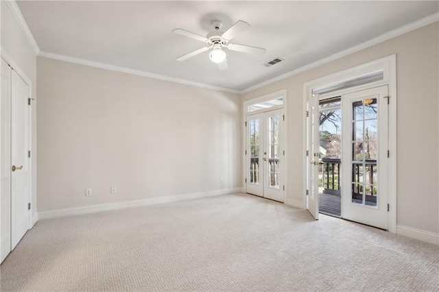 unfurnished room with light carpet, visible vents, french doors, and ornamental molding