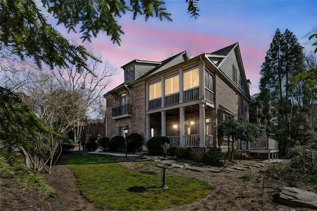 exterior space with brick siding and a porch