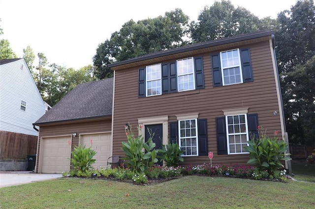 colonial-style house featuring a garage and a front yard