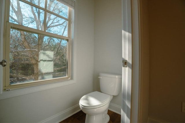 bathroom with baseboards and toilet