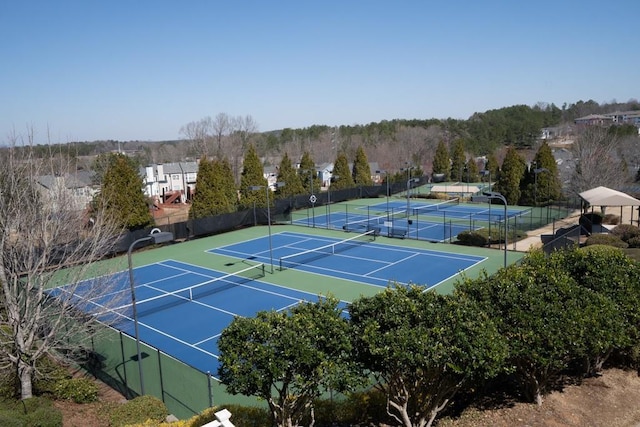 view of sport court featuring fence