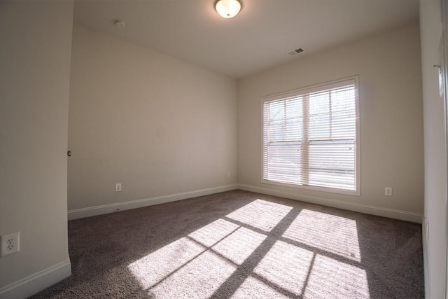 unfurnished room featuring visible vents, baseboards, and carpet floors