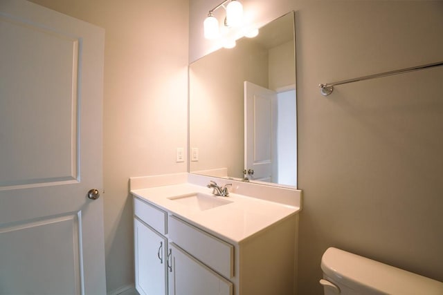 bathroom with toilet and vanity